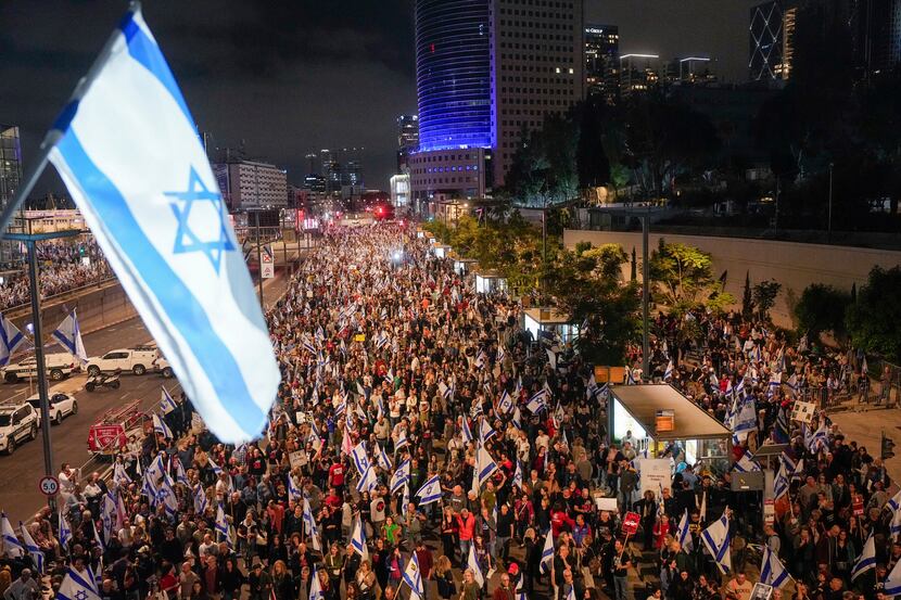 People protest against Israeli Prime Minister Benjamin Netanyahu's government and call for...