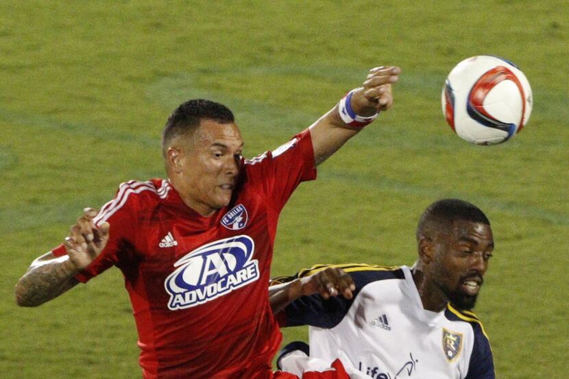 FC Dallas forward Blas Perez (7) and Real Salt Lake defender Aaron Maund (21) jump up for a...