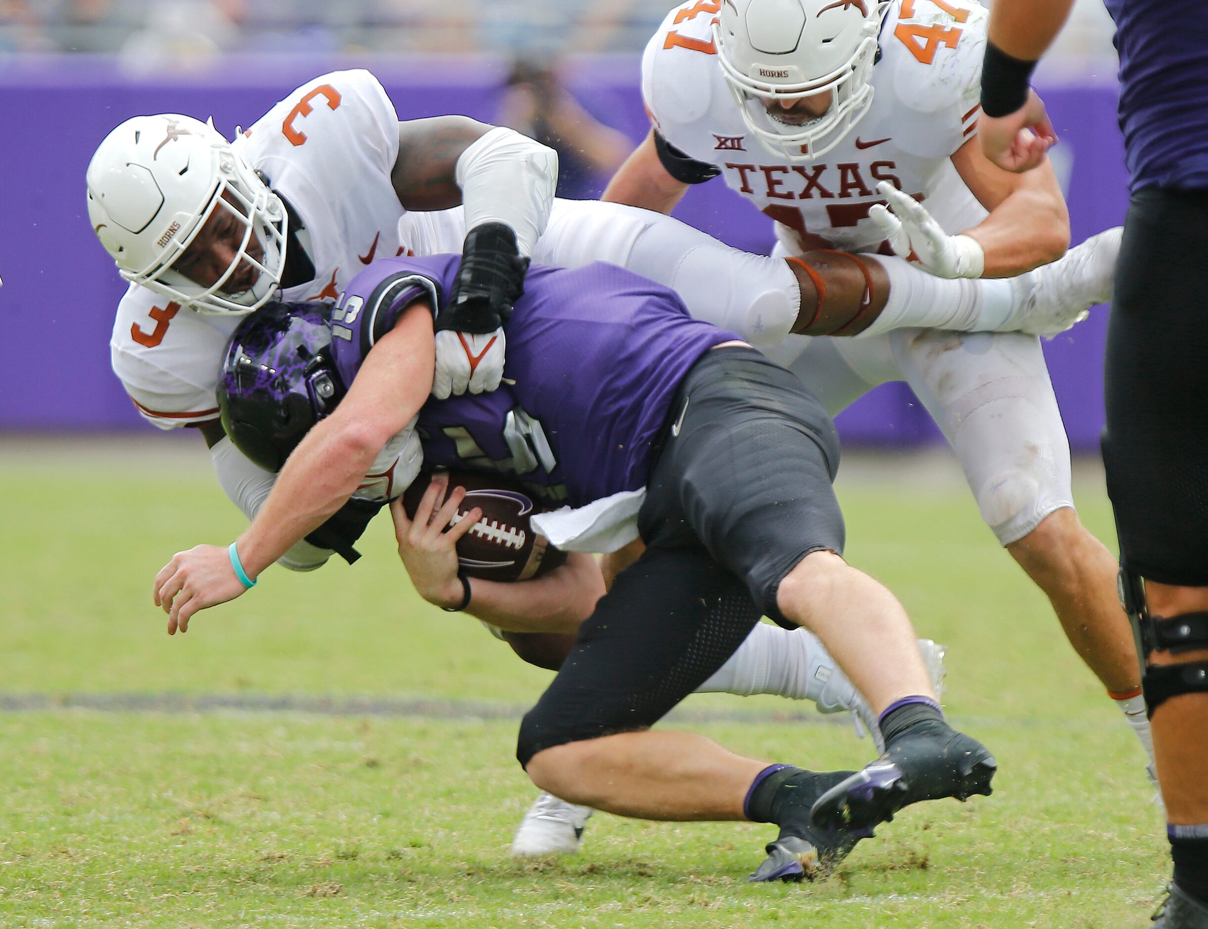 Texas Longhorns linebacker Jacoby Jones (3) takes down TCU Horned Frogs quarterback Max...