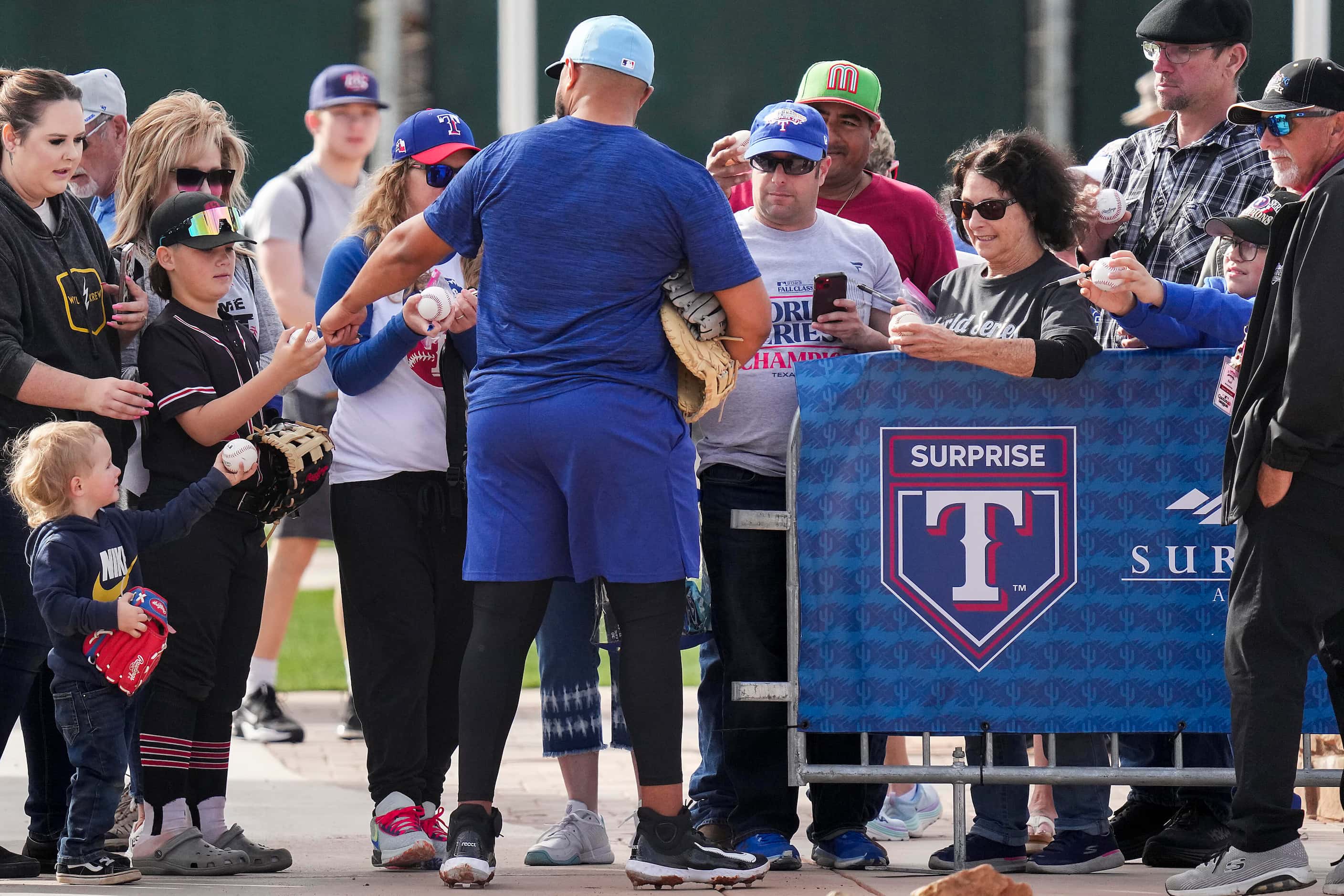 Texas Rangers infielder Abimelec Ortiz signs autographs during a spring training workout at...