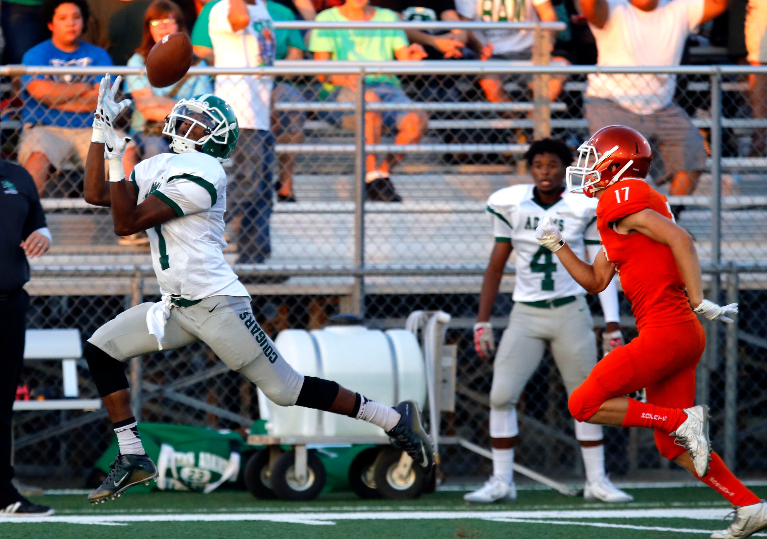 (TXHSFB) Bryan Adam's WR Nathan Stewart (1) grabs a long pass for a touchdown, trailed by...