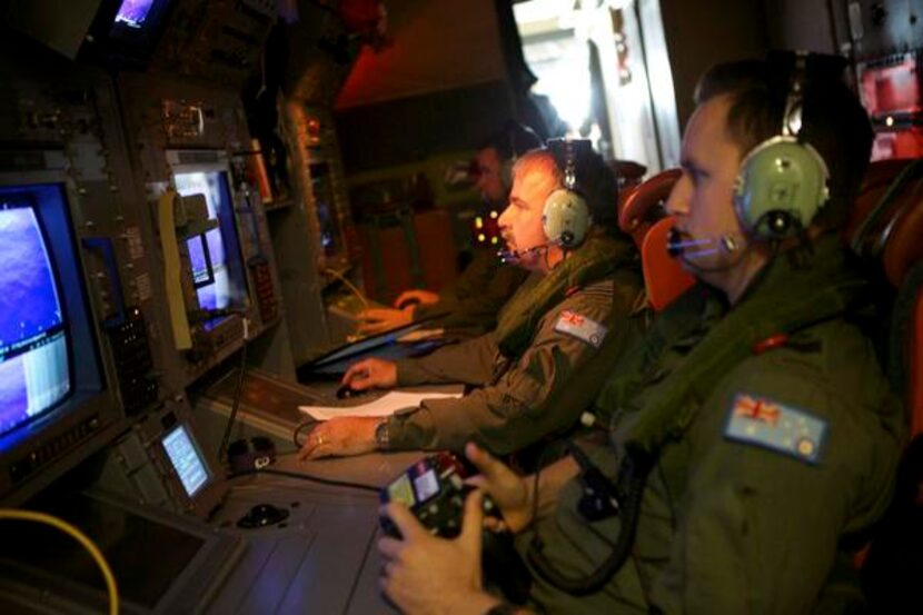 
Crewmen on a Royal Australian Air Force plane monitored screens during a search for the...