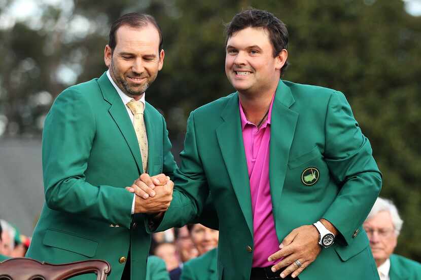 AUGUSTA, GA - APRIL 08:  Patrick Reed (R) of the United States is congratulated by Sergio...