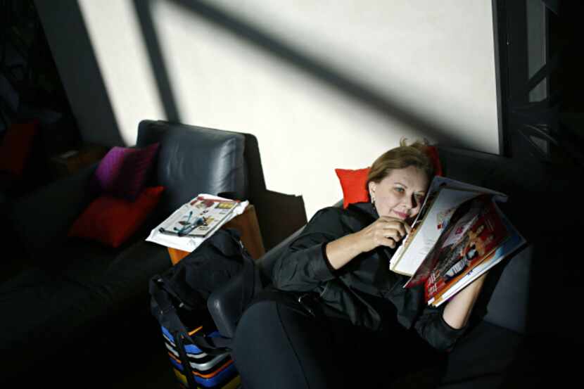 Lieia Weber of Brazil reclines while reading a magazine at the Centurion Lounge Thursday,...