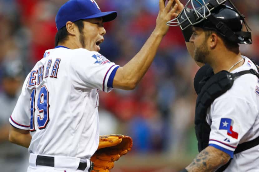 Texas Rangers relief pitcher Koji Uehara (19) celebrates a strike out for the third out in...
