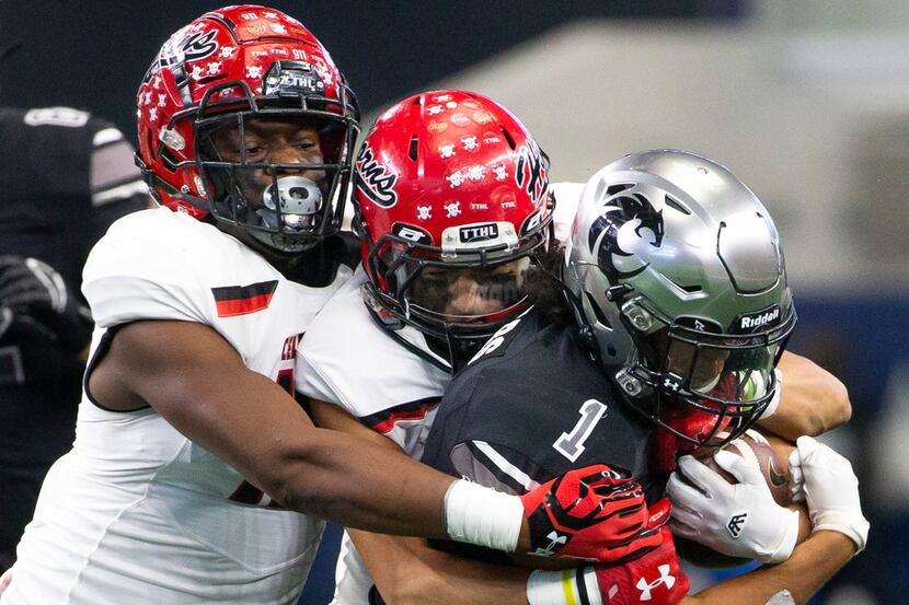 Cedar Hill defense takes down Denton Guyer running back Kaedric Cobbs (1) during the Class...