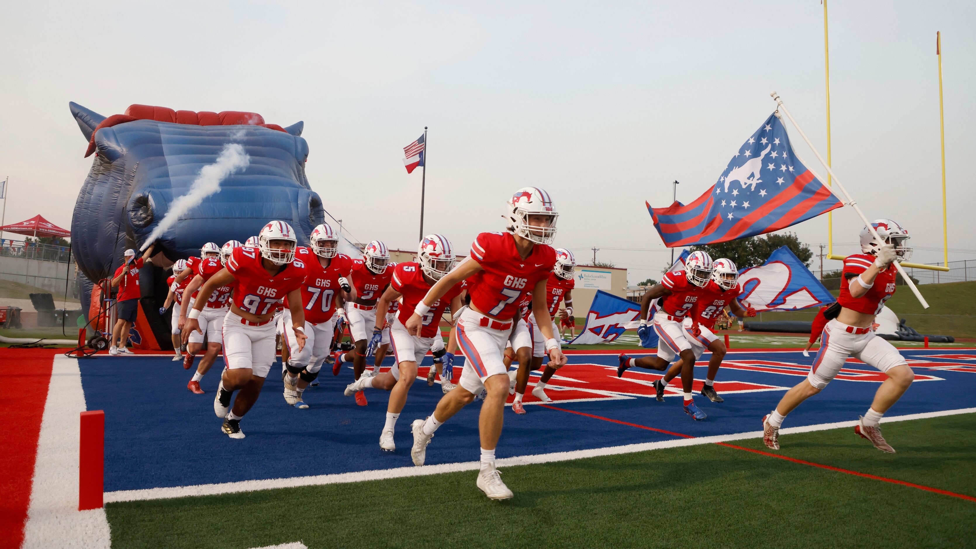 The Grapevine football team rushes the field prior to playing Frisco Wakeland during a high...