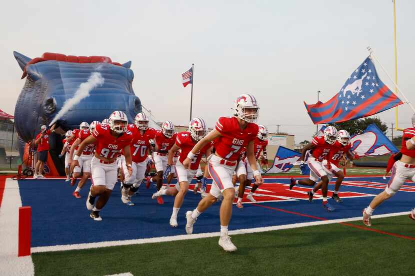The Grapevine football team rushes the field prior to playing Frisco Wakeland during a high...