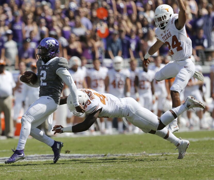 TCU Horned Frogs quarterback Trevone Boykin (2) tries to evade Texas Longhorns defensive end...