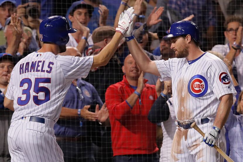 Chicago Cubs' Cole Hamels, left, celebrates his home run against the Pittsburgh Pirates wit...