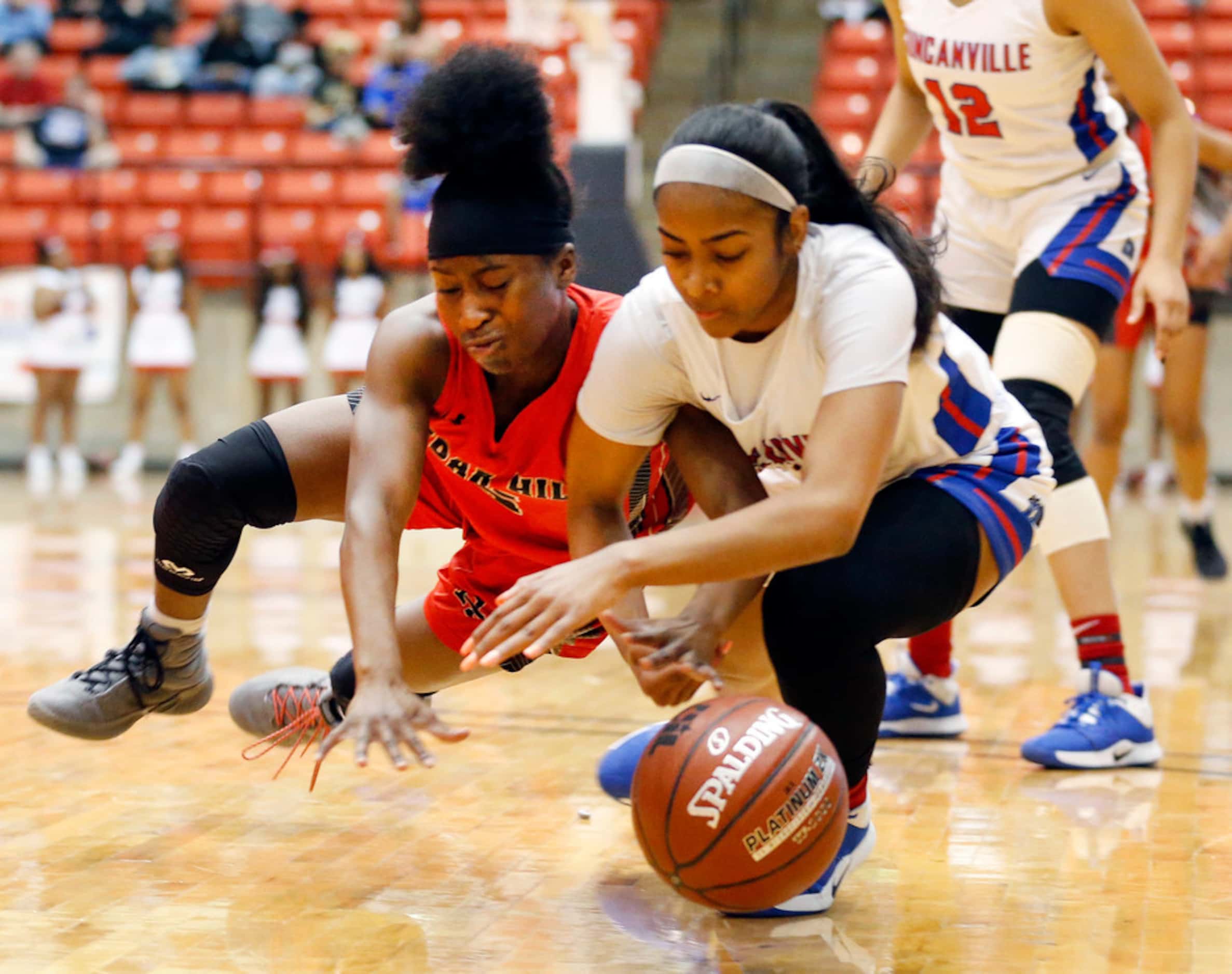 Cedar Hills' Iyonia Smith (5) and Duncanville's  Deja Kelly (25) go for a loose ball during...