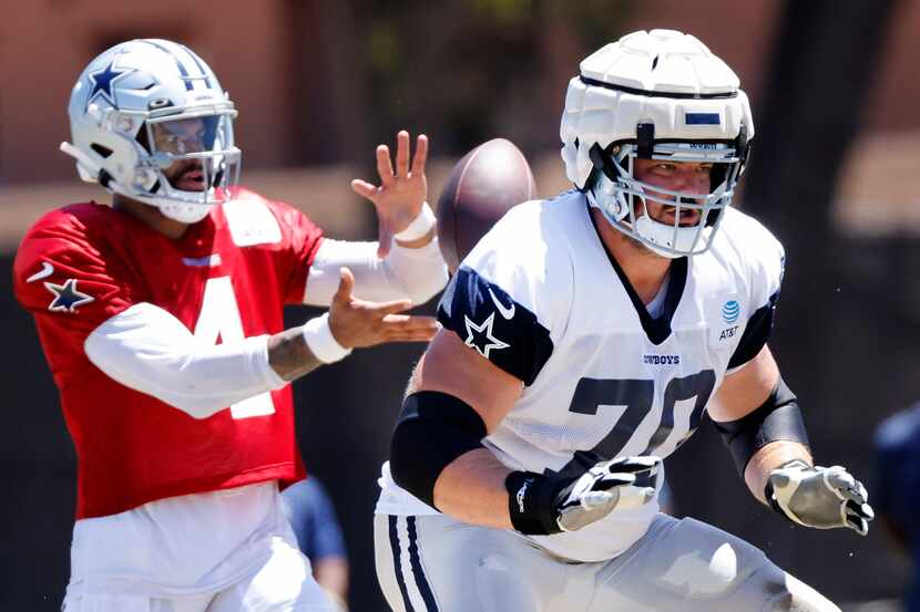 Dallas Cowboys guard Zack Martin (70) blocks for quarterback Dak Prescott (4) during a...