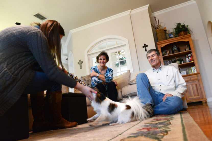 Carl and Annette Reese spend time with their visiting daughter Lauren and their dog Buddy in...