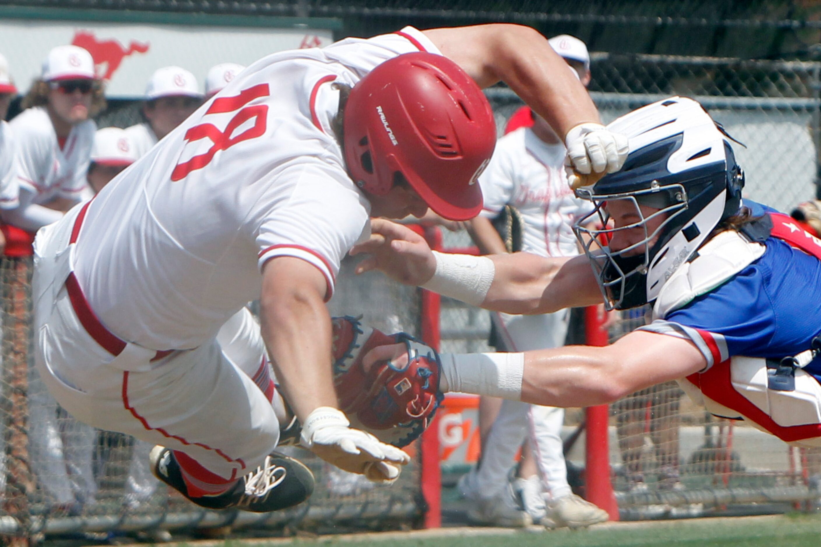 Midlothian Heritage catcher Carter Rutenbar (9), right, tags out Grapevine's Jace Christian...