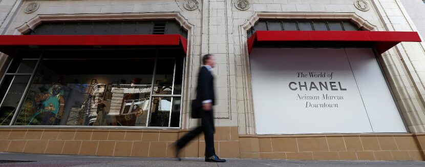 A pedestrian walks by the Neiman Marcus department store on Main Street in downtown Dallas.