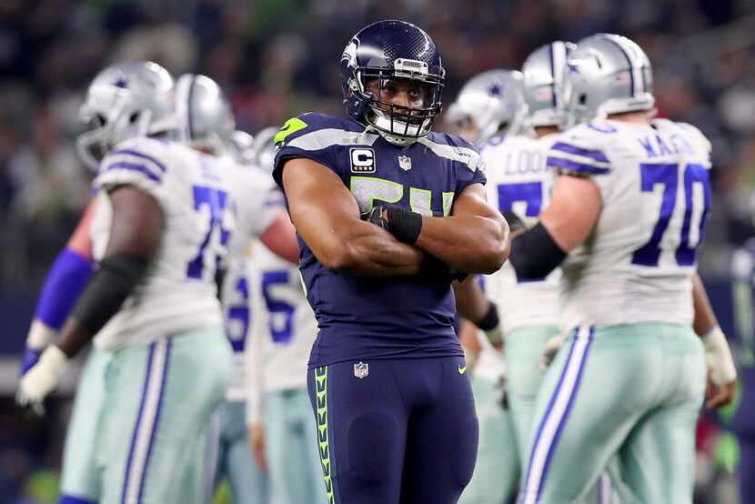 ARLINGTON, TX - DECEMBER 24:  Bobby Wagner #54 of the Seattle Seahawks reacts after the...