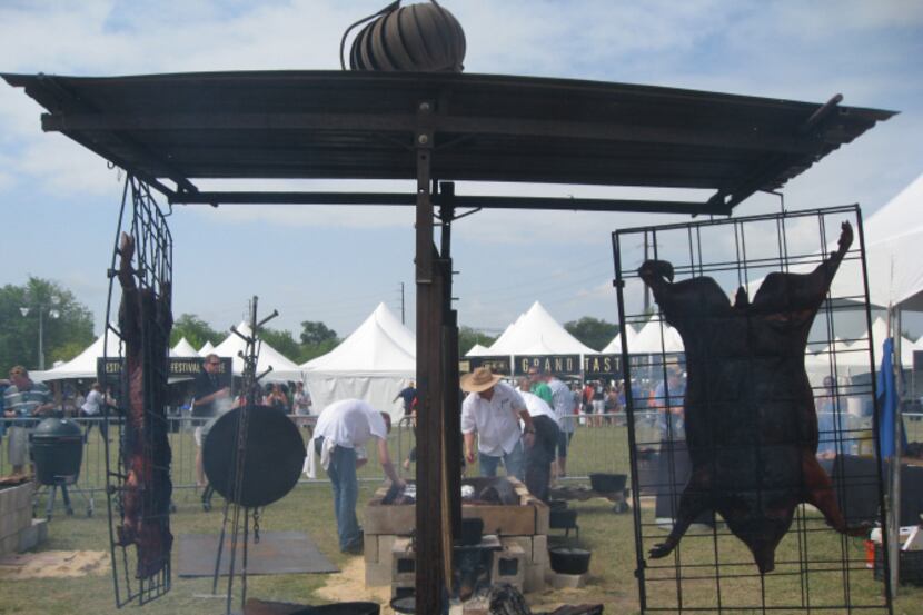 Chef Tim Byres of Smoke in Dallas (in the hat) used vertical pig roasters to feed a crowd at...