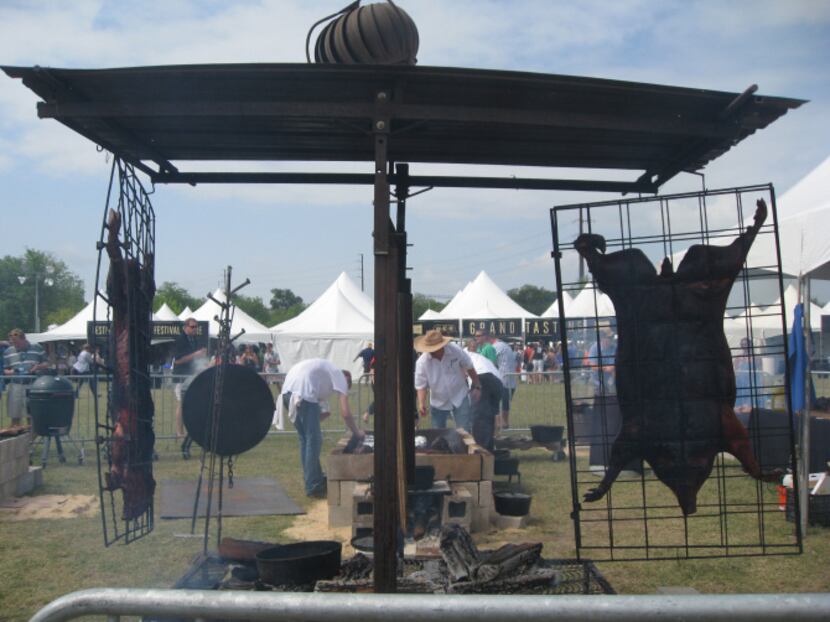 Chef Tim Byres of Smoke in Dallas (in the hat) used vertical pig roasters to feed a crowd at...