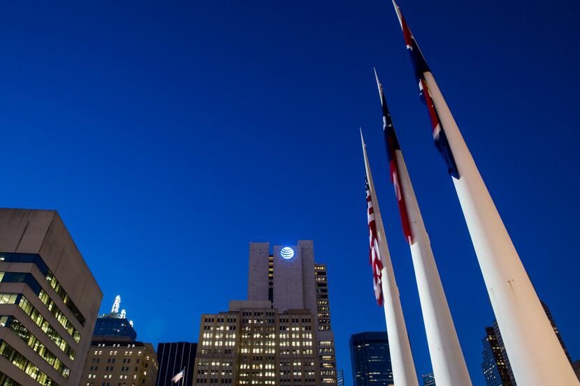 The AT&T headquarters building, surrounded by other downtown buildings and flags in front of...
