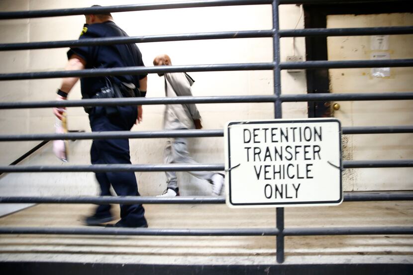 A prisoner escorted to the sally port of North Tower Detention Facility in the Lew Sterrett...