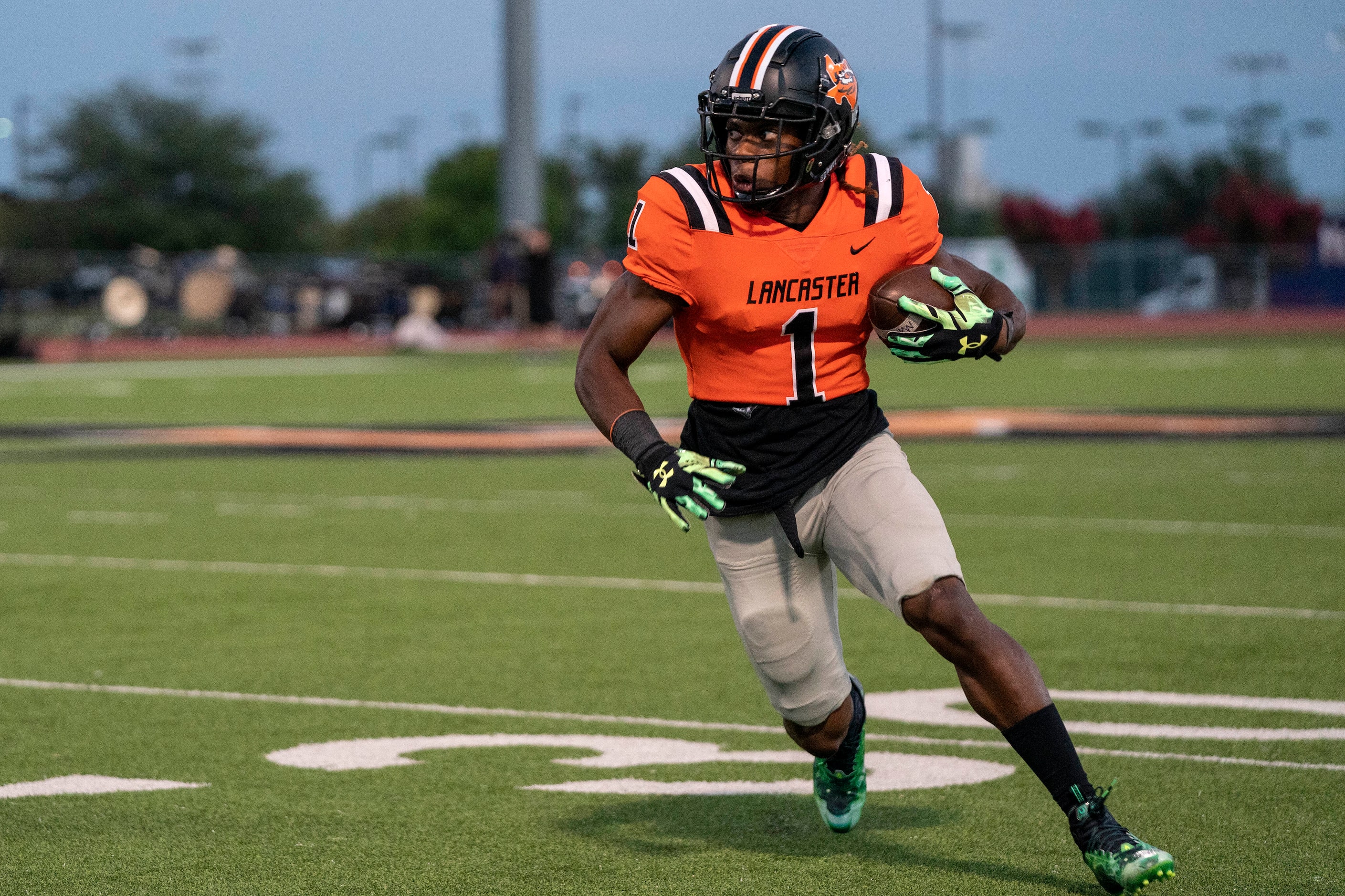 Lancaster senior running back Kyson Brown (1) turns upfield on a touchdown run against...