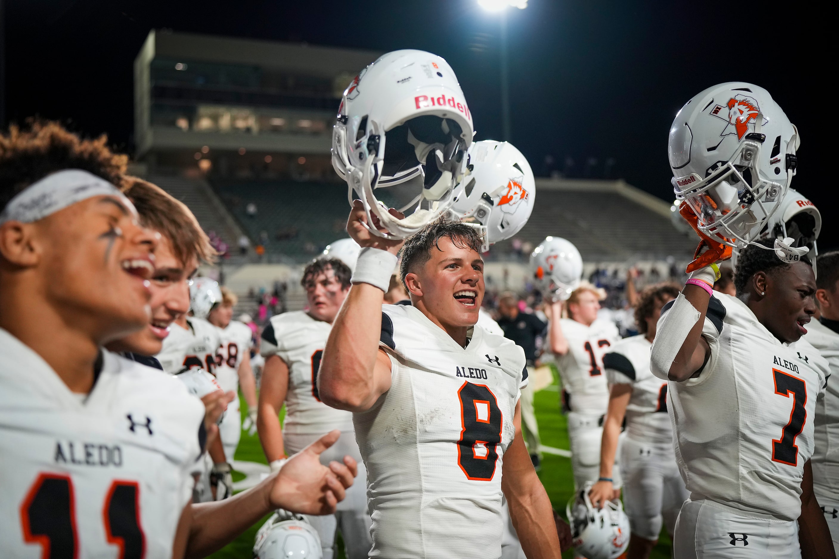 Aledo quarterback Hauss Hejny (8) celebrates with teammates after a victory over Denton Ryan...