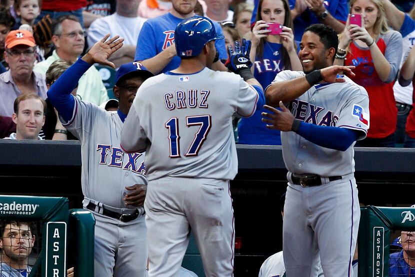 HOUSTON - MAY 11:  Elvis Andrus #1 of the Texas Rangers is congratulated by Elvis Andrus and...