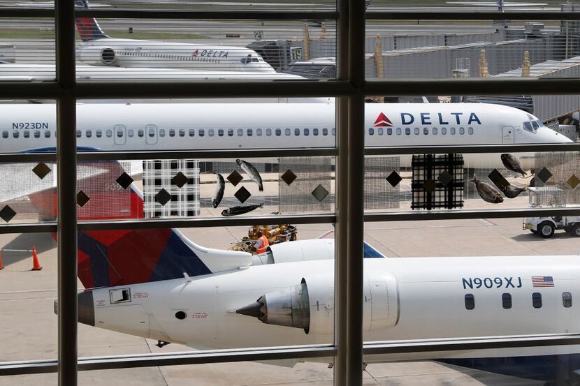 FILE - In this Monday, Aug. 8, 2016, file photo, Delta Air Lines planes are parked at Ronald...