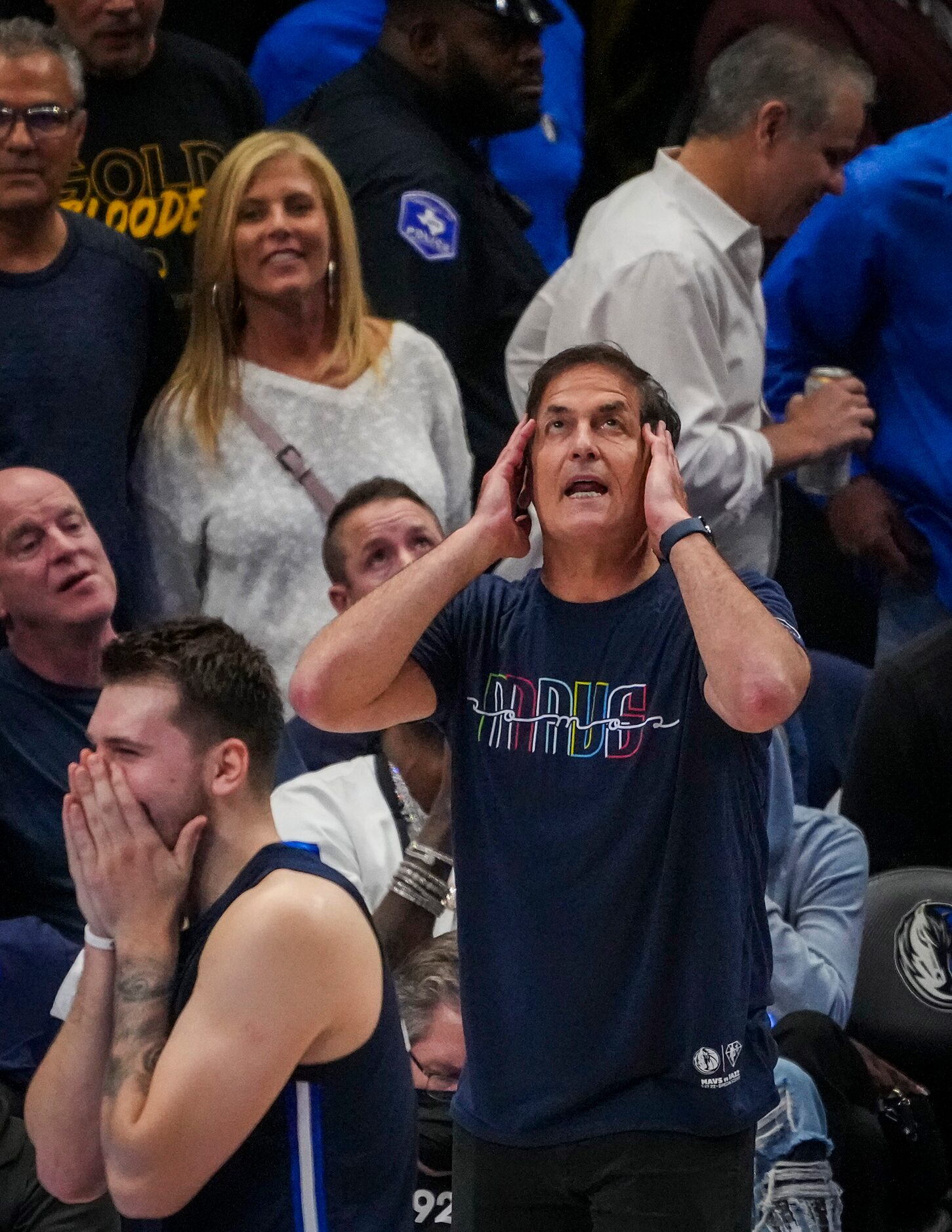 Dallas Mavericks guard Luka Doncic  and owner Mark Cuban react after an offensive foul call...