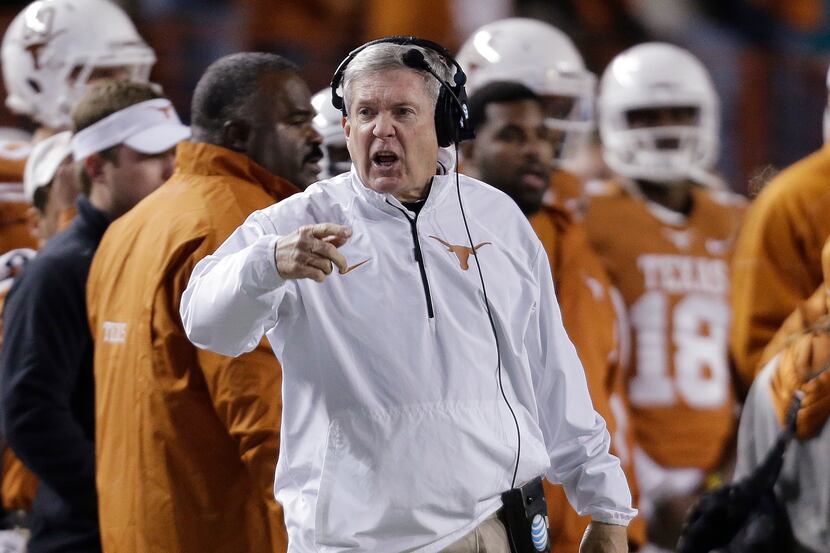 Texas coach Mack Brown talks to his players from the sideline during the second half of an...