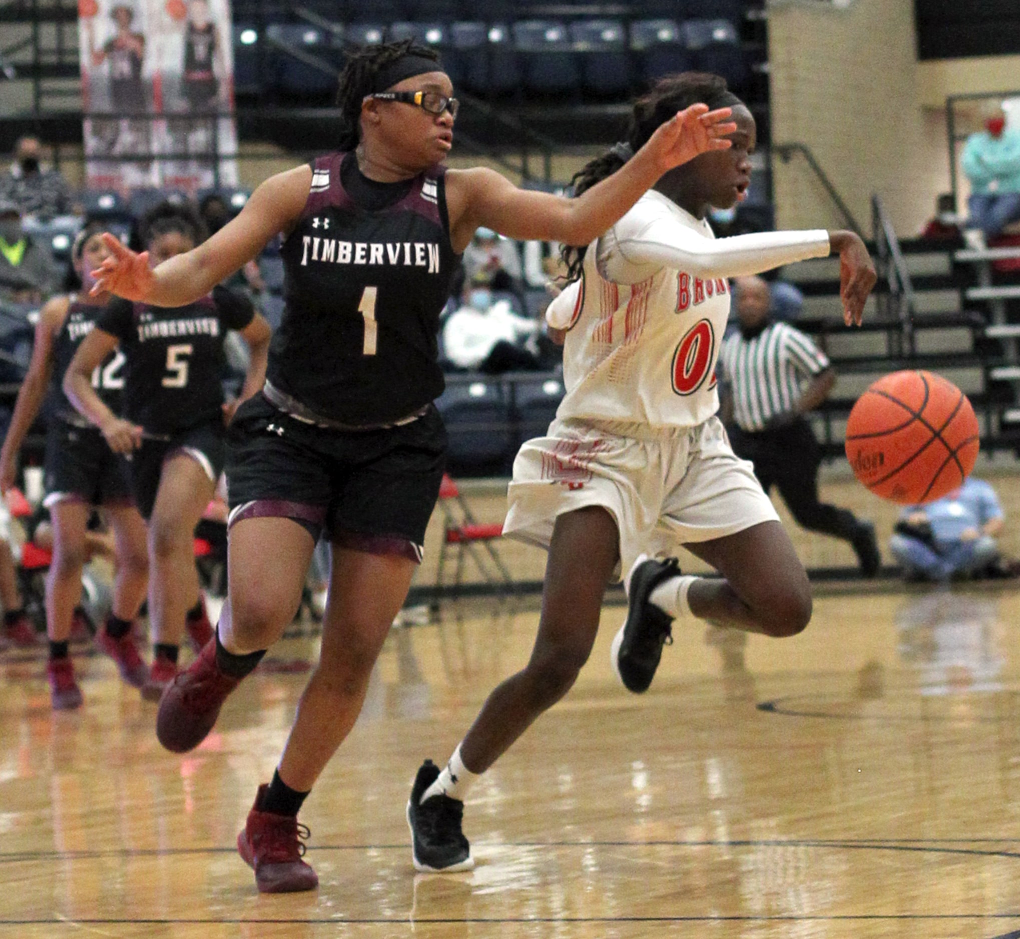 Mansfield Timberview's Tamaiya Mims (1) chases Mansfield Legacy guard Coniah Cooley (00)...