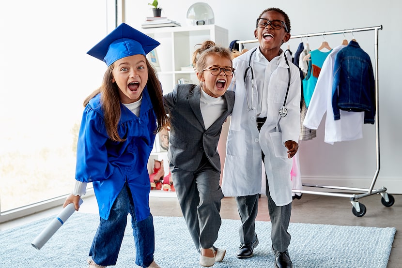 Three excited kids dressed in costumes