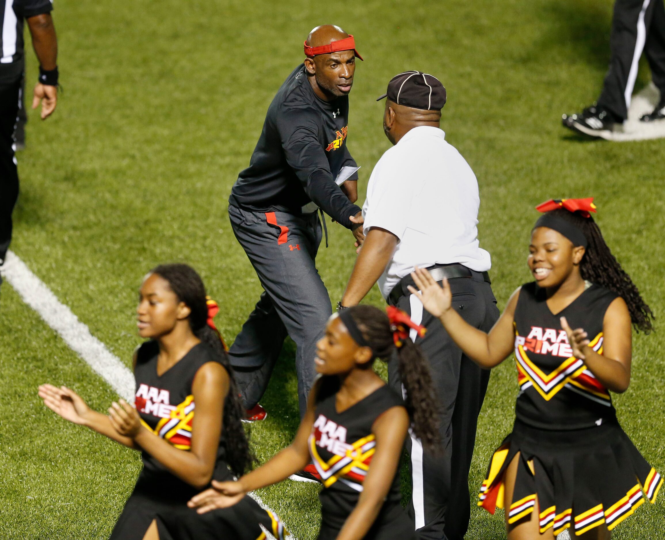 AAA Prime U coach Deion Sanders shakes hands with officials following a high school football...