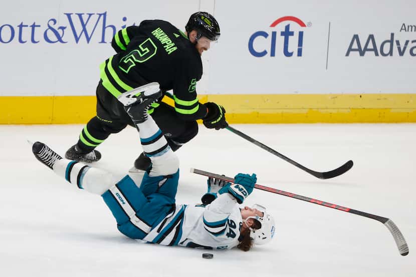 San Jose Sharks left wing Alexander Barabanov (94) falls as he battles for the puck with...