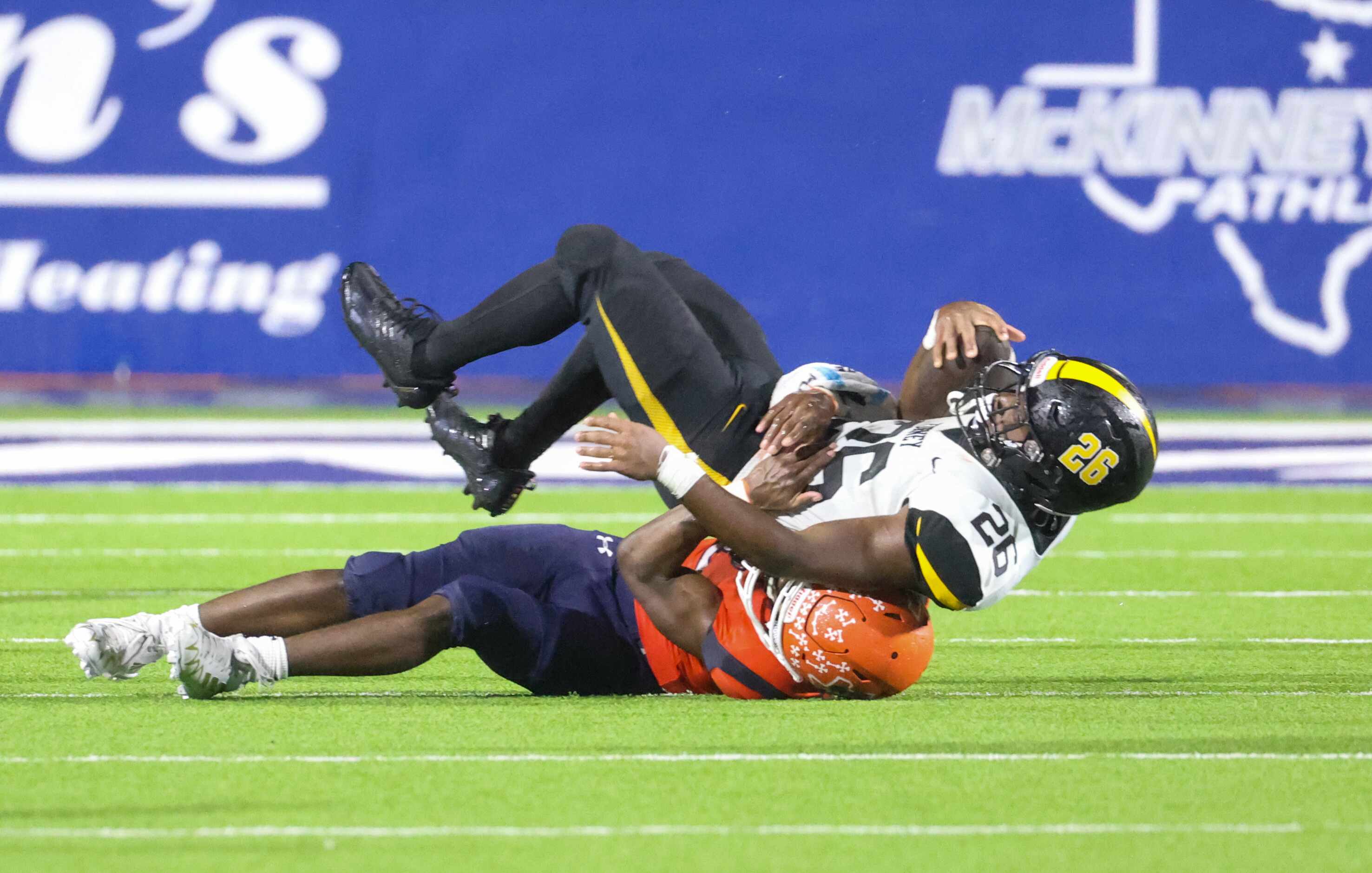 Forney running back Javian Osborne (26) is thrown to the ground by McKinney North cornerback...