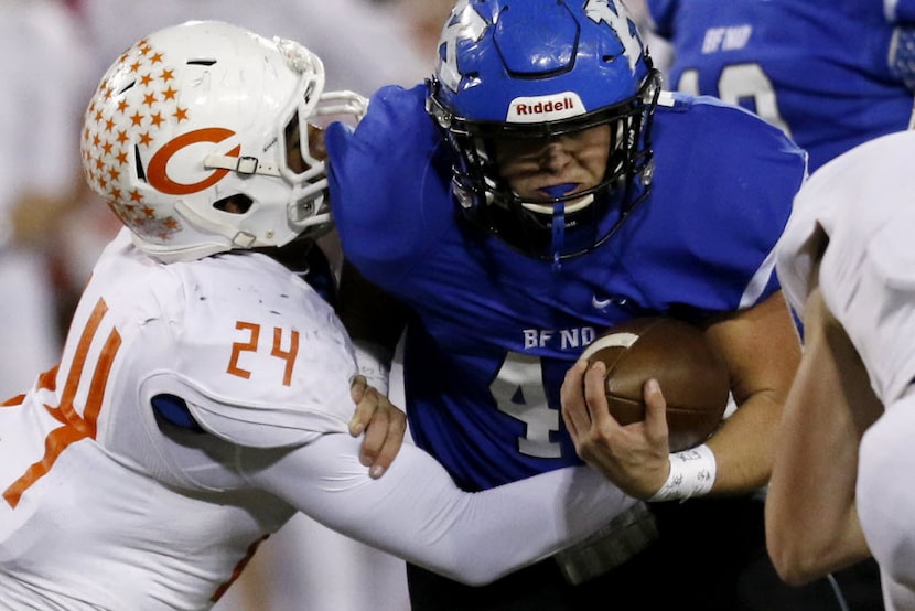 Celina's Jose Torres tackles Krum's Haeden Knight in the 1st half as Celina faces Krum in...