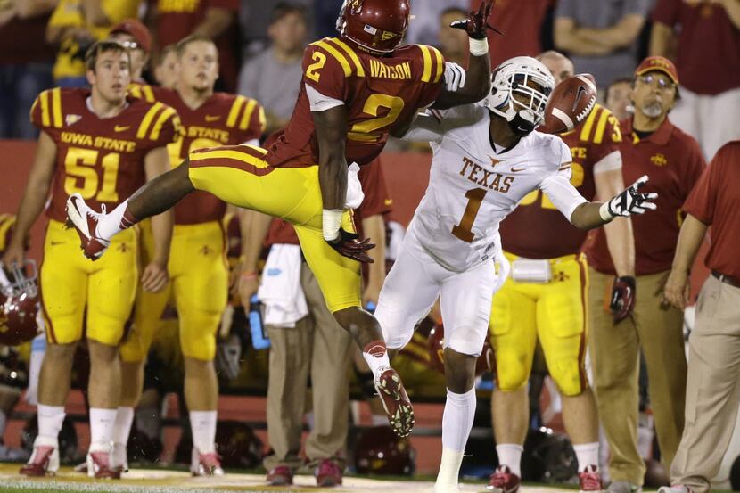 Iowa State's Jansen Watson (left) breaks up a pass intended for Texas wide receiver Mike Davis.