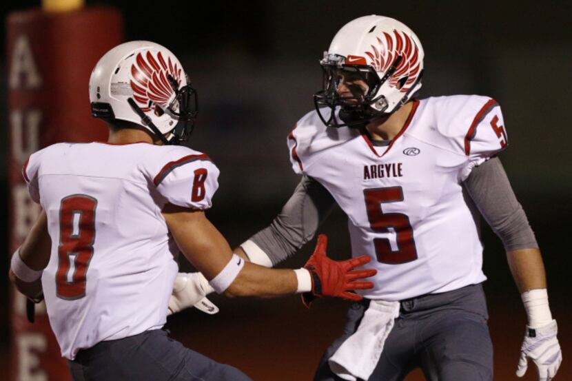 Argyle's Ian Sadler (5) celebrates with Hunter Treadwell (8) after scoring a touchdown...