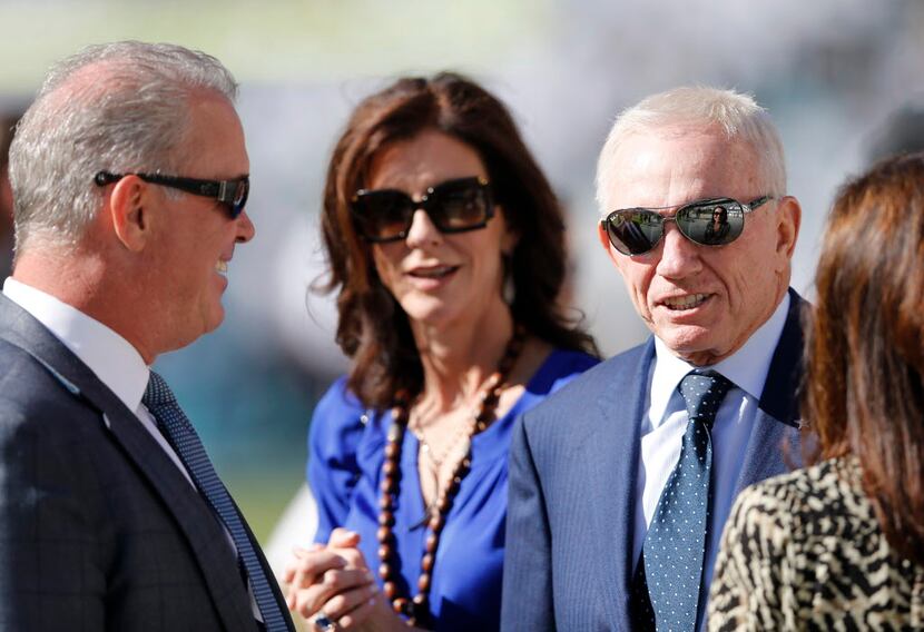 Dallas Cowboys owner Jerry Jones on the sidelines with son Stephen Jones and family before a...