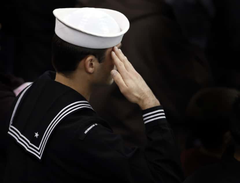 A sailor salutes during the memorial service for former Navy SEAL Chris Kyle on Monday,...