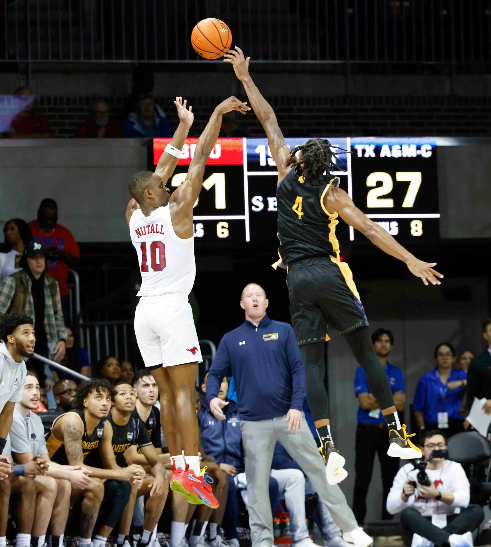 Southern Methodist guard Zach Nutall (10), left, shoots a three-pointer as Texas A&M-Comm’s...