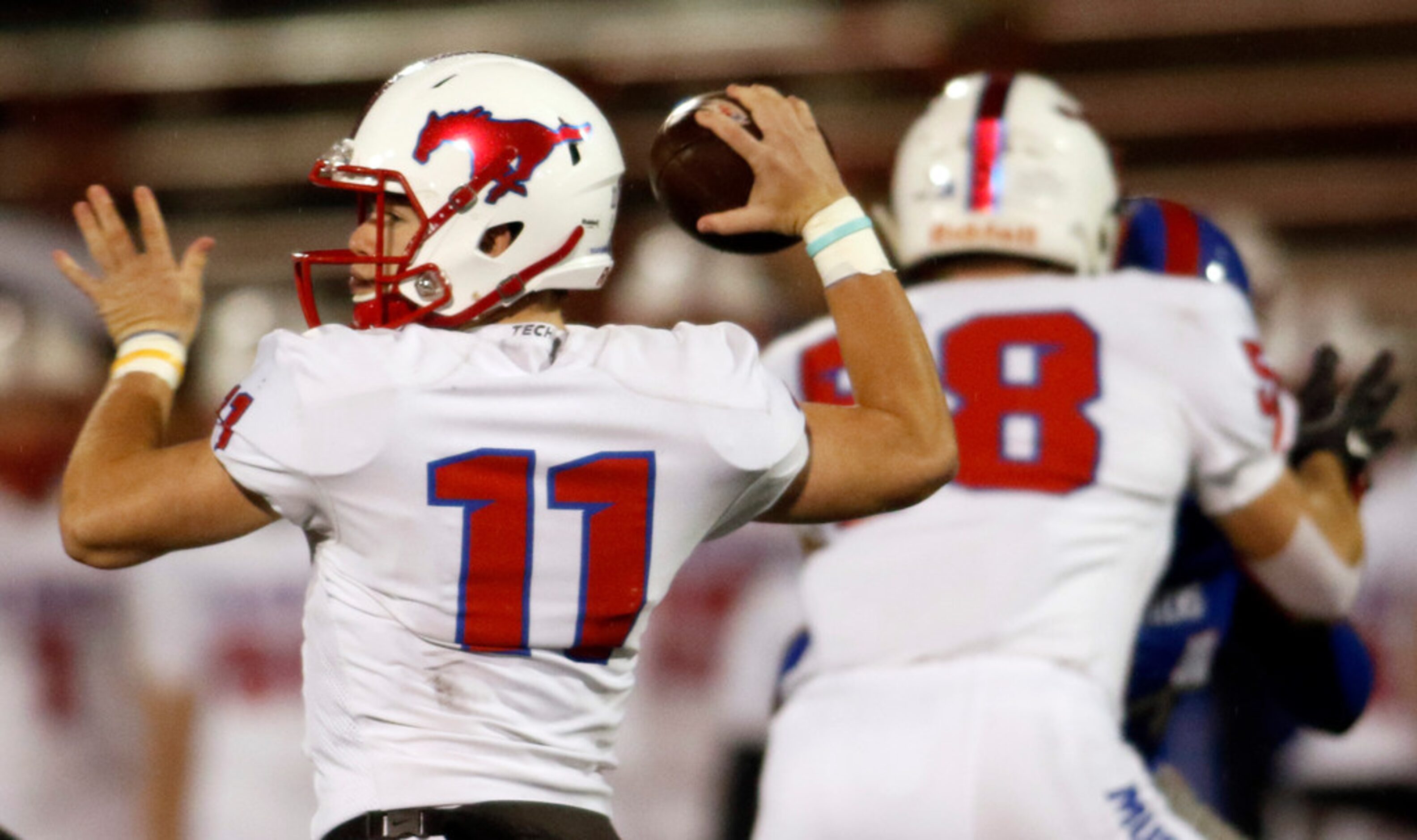 Richardson Pearce quarterback Bo Brewer (11) gets off a pass during first quarter action...