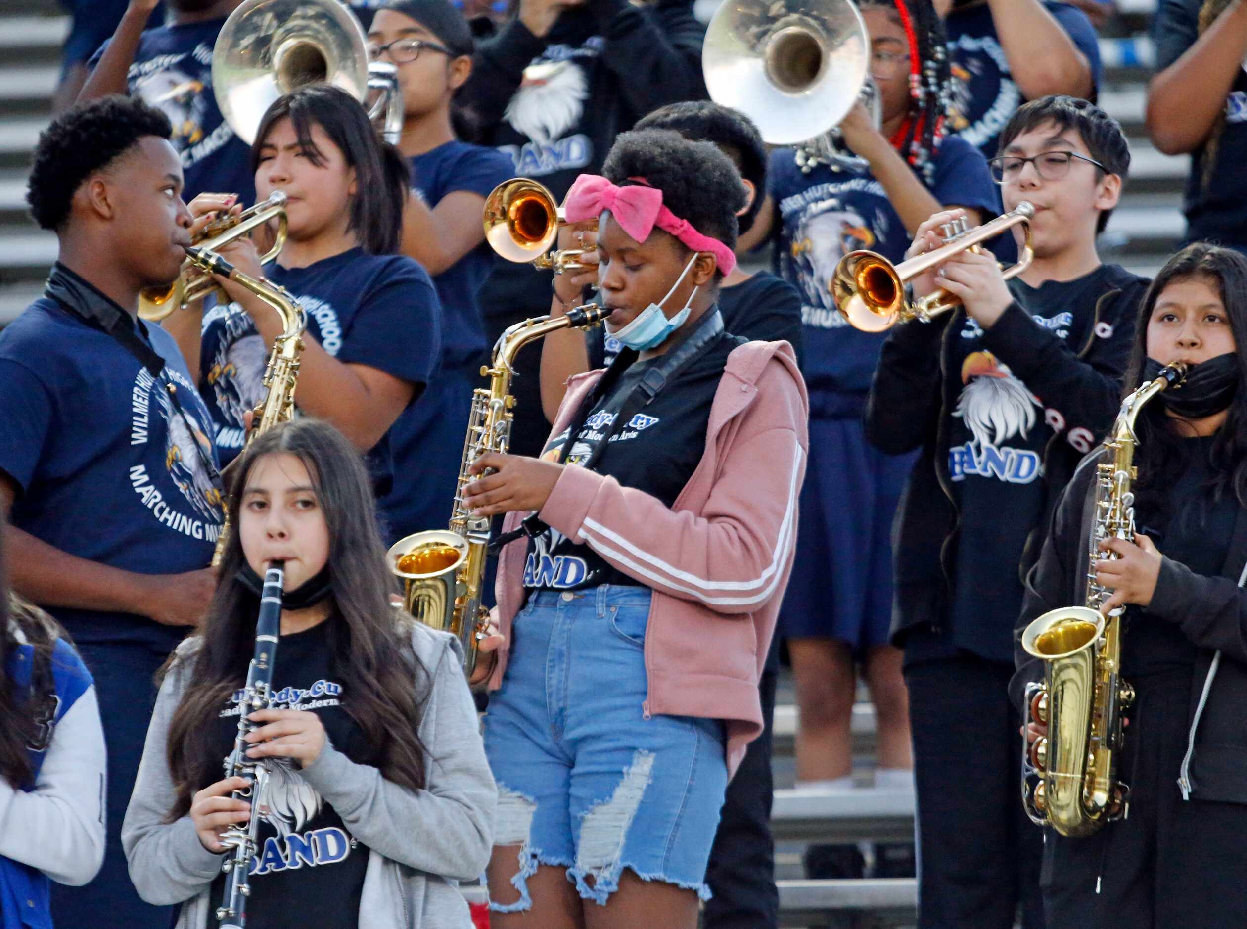 The Wilmer-Hutchikns high band performs during the start of a high school football game...