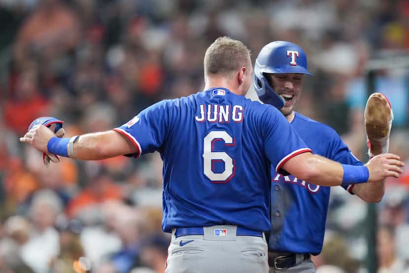 Texas Rangers left fielder Evan Carter (32) celebrates with Texas Rangers third baseman Josh...