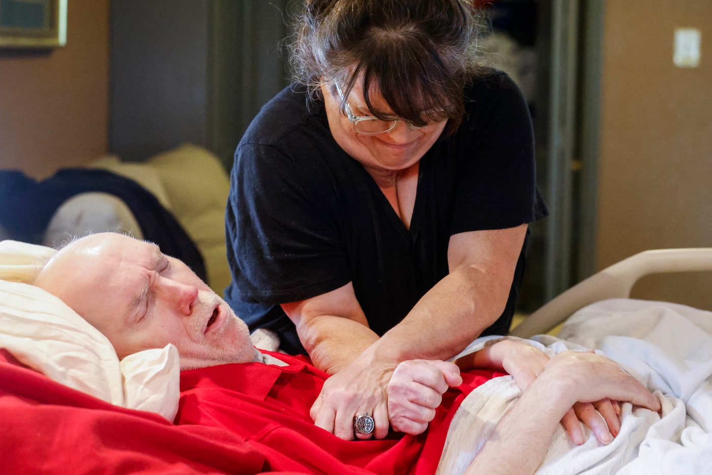 Community care attendant Angela Blankenship helps Rick Frame, 59, of Arlington, to cough by...