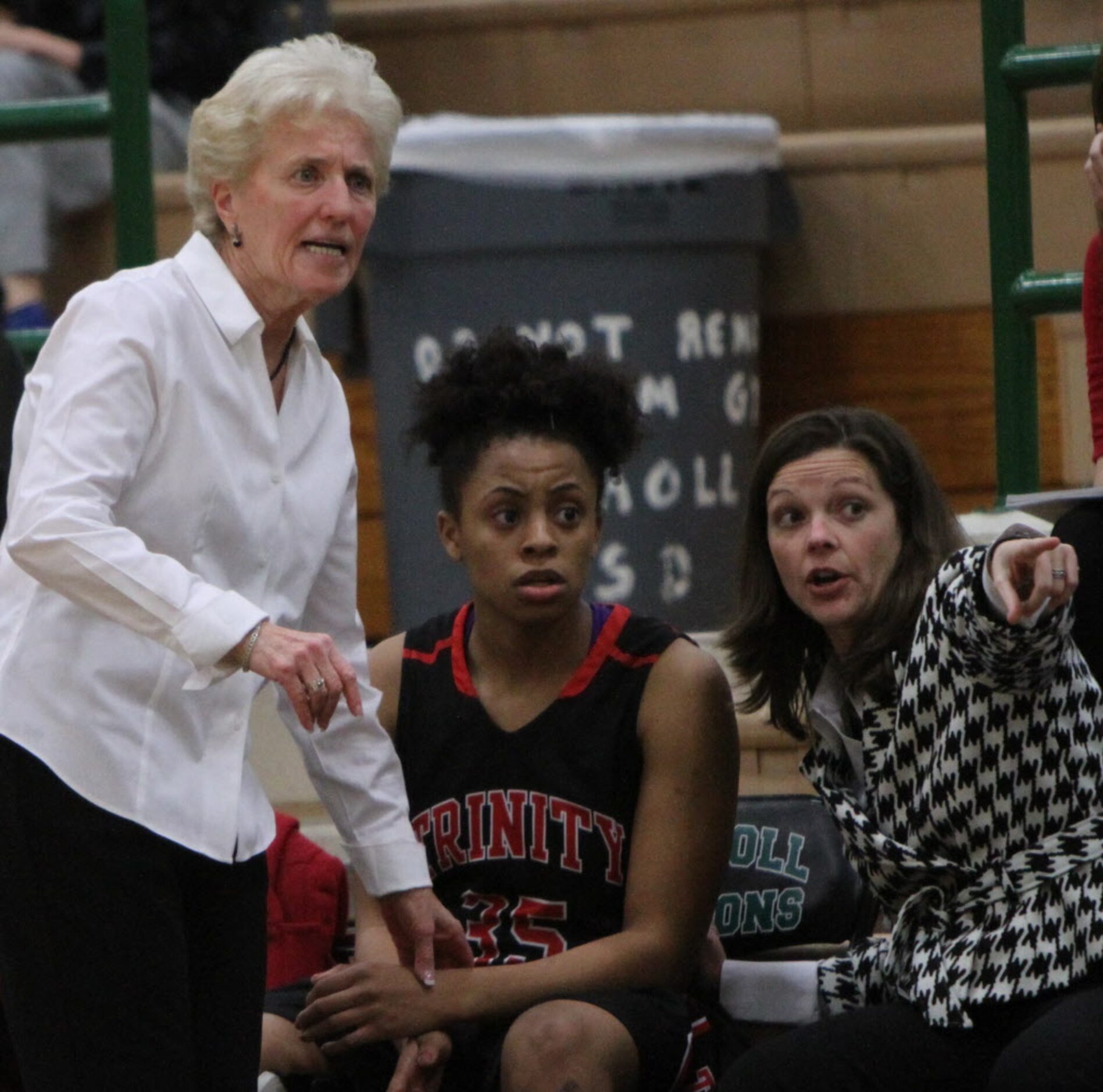 Euless Trinity head coach Sue Cannon, left, watches intently along the team bench area...