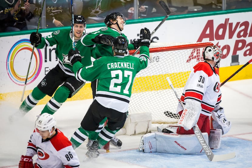 Dallas Stars left wing Curtis McKenzie (11) celebrates with right wing Adam Cracknell (27)...