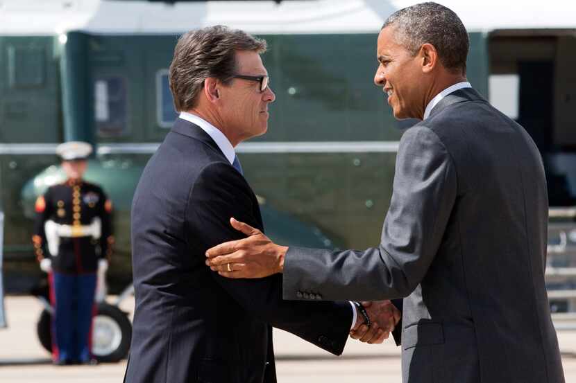 President Barack Obama, right, and Texas Gov. Rick Perry shake hands as Obama arrives in...