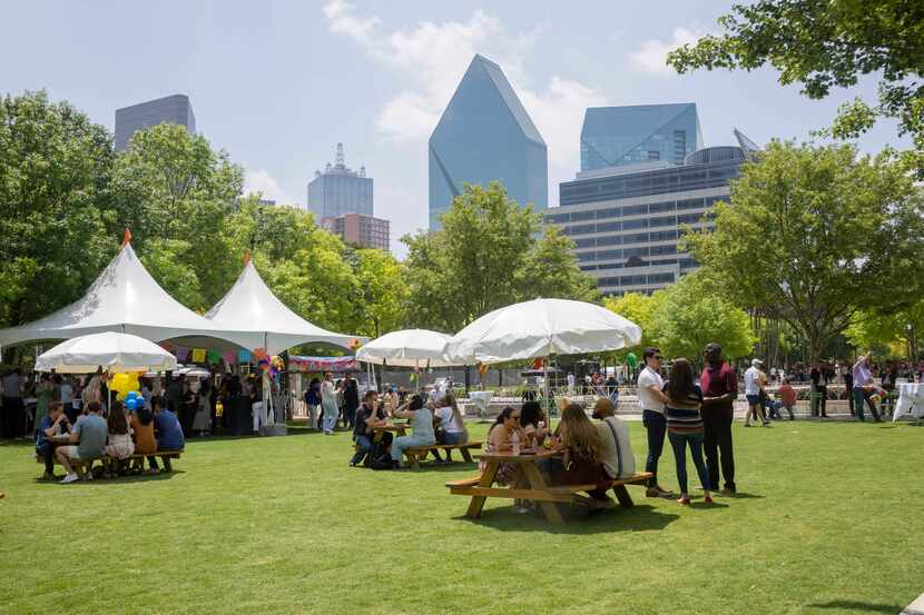 People find shade in this photo taken on a sunny day at Klyde Warren Park in Dallas on...