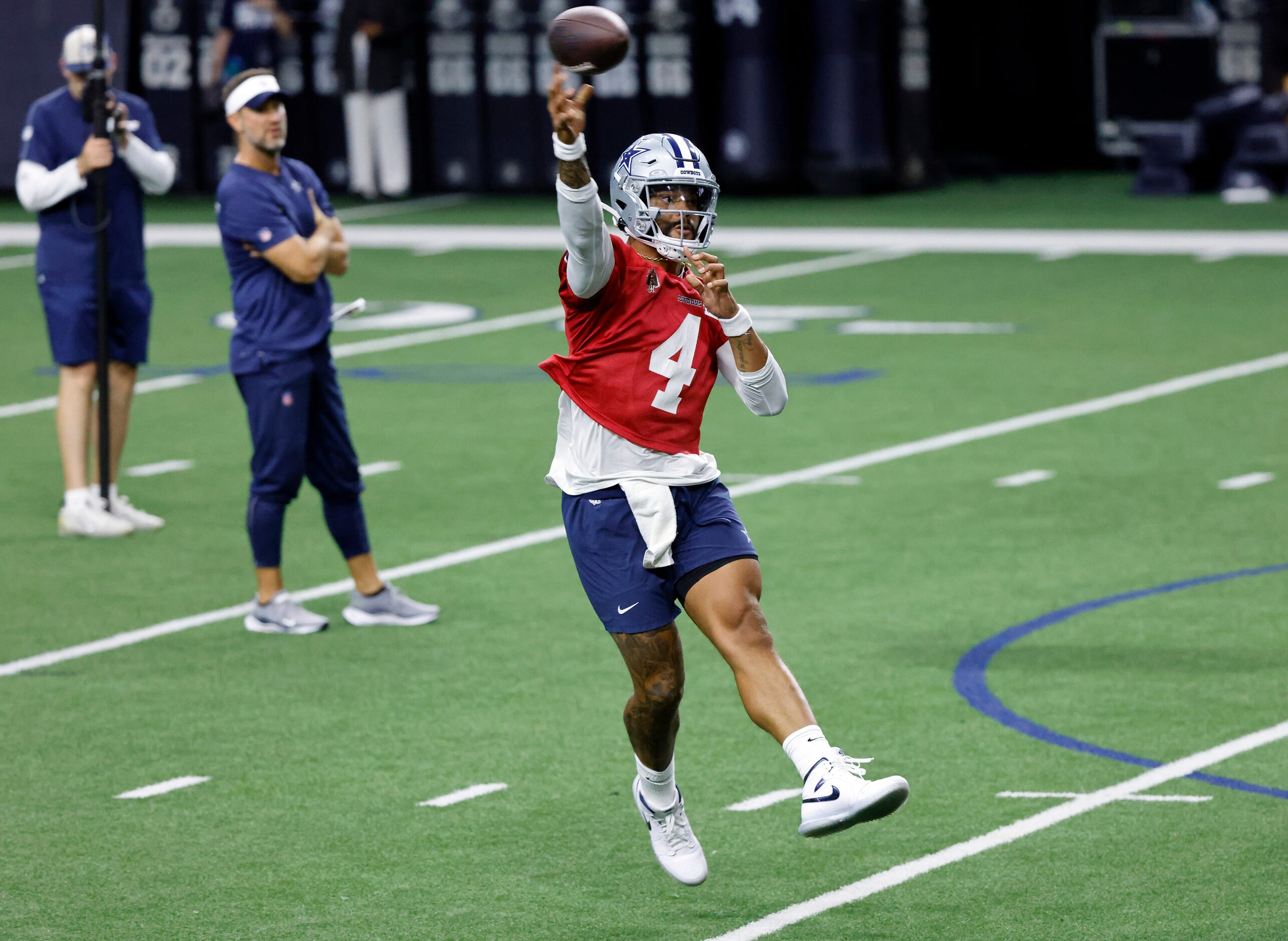 Dallas Cowboys quarterback Dak Prescott (4) throws on the run as he completes a throwing...